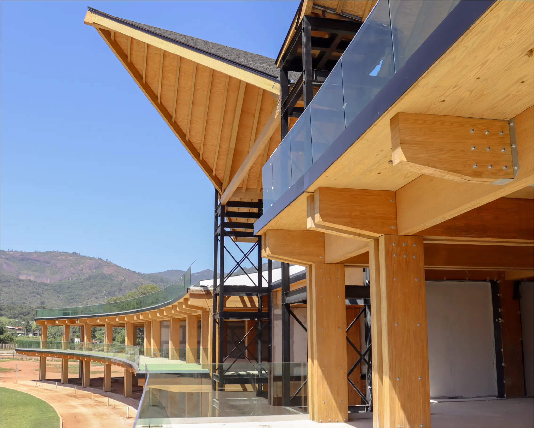 Fachada do Open Mall Praça Pitiguari com estrutura em madeira engenheirada e integração com o entorno verde.
